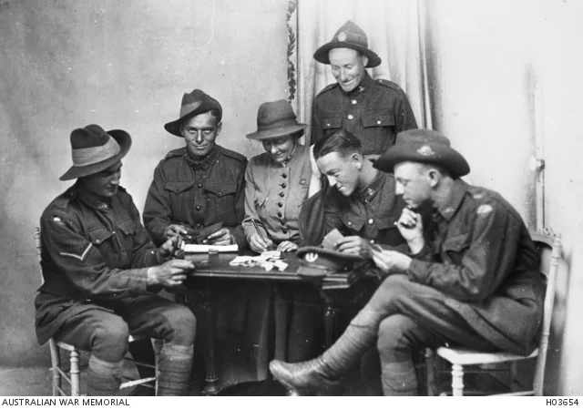 Rout playing cards with Australian, New Zealand and South African soldiers, 1919. AWM H03654.